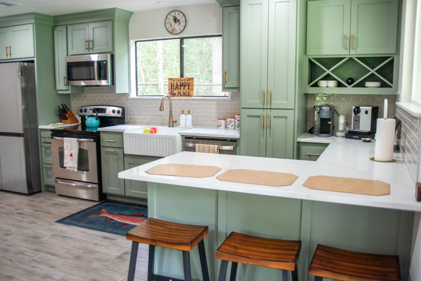 Light green kitchen with island and stools