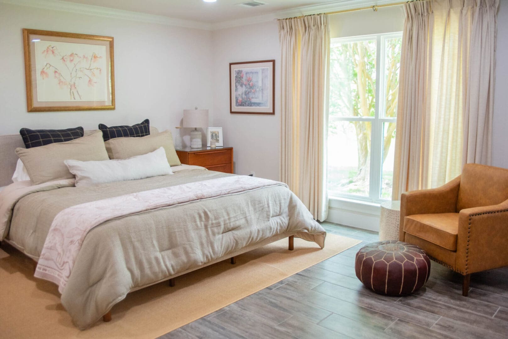 Cozy neutral bedroom with armchair and window