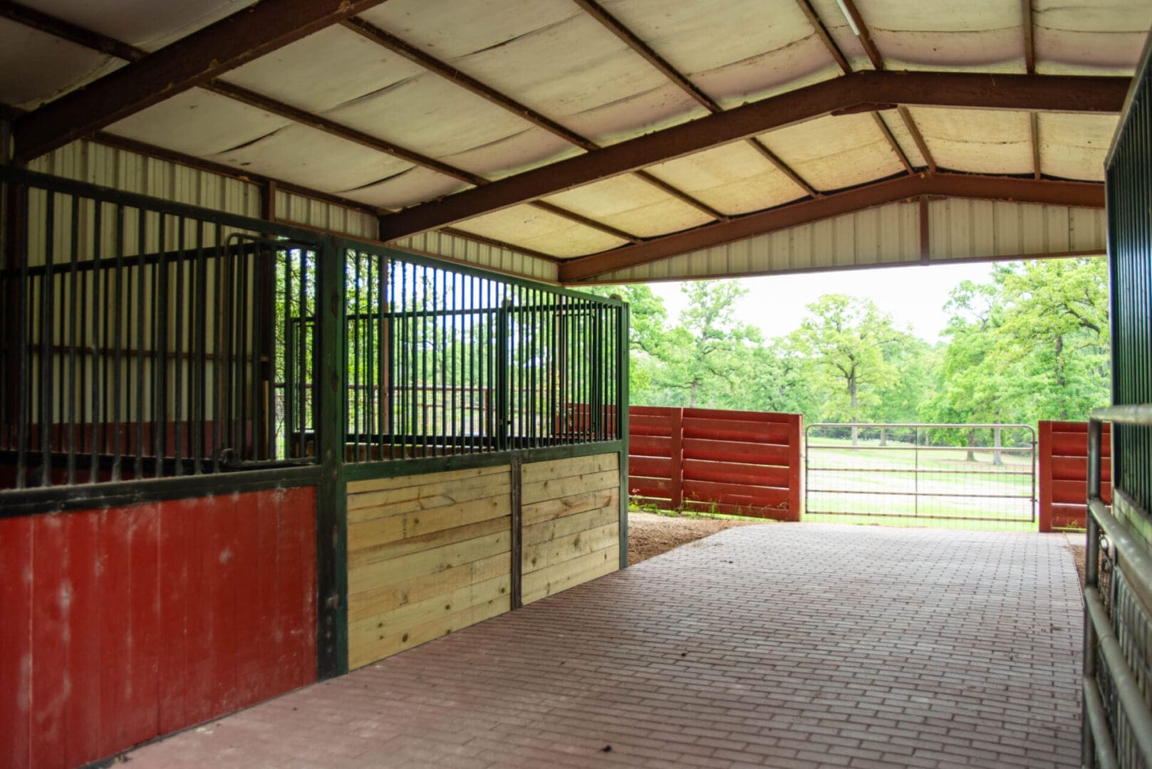 Covered stable aisle with stalls and gate
